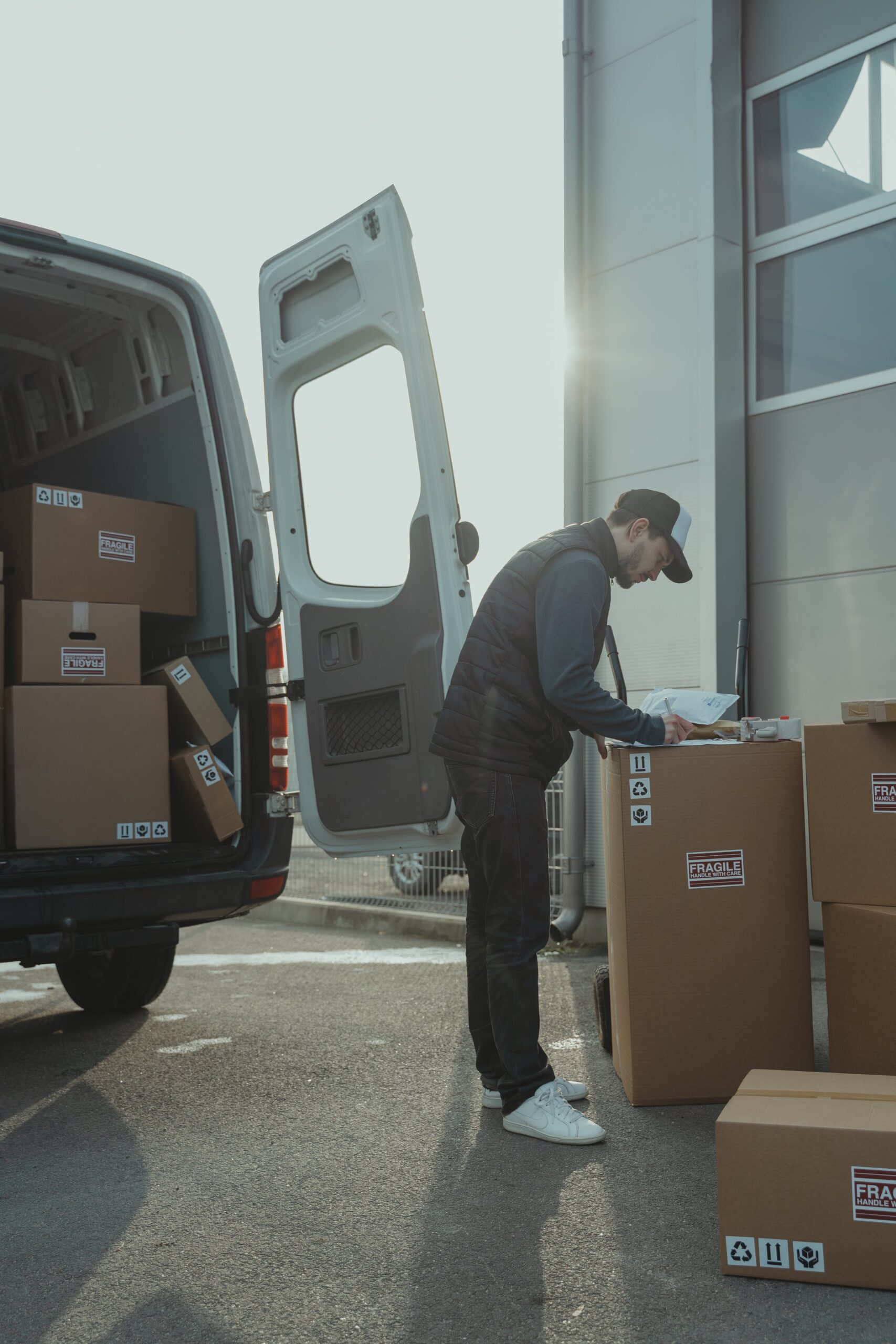 A man standing next to a van with boxes